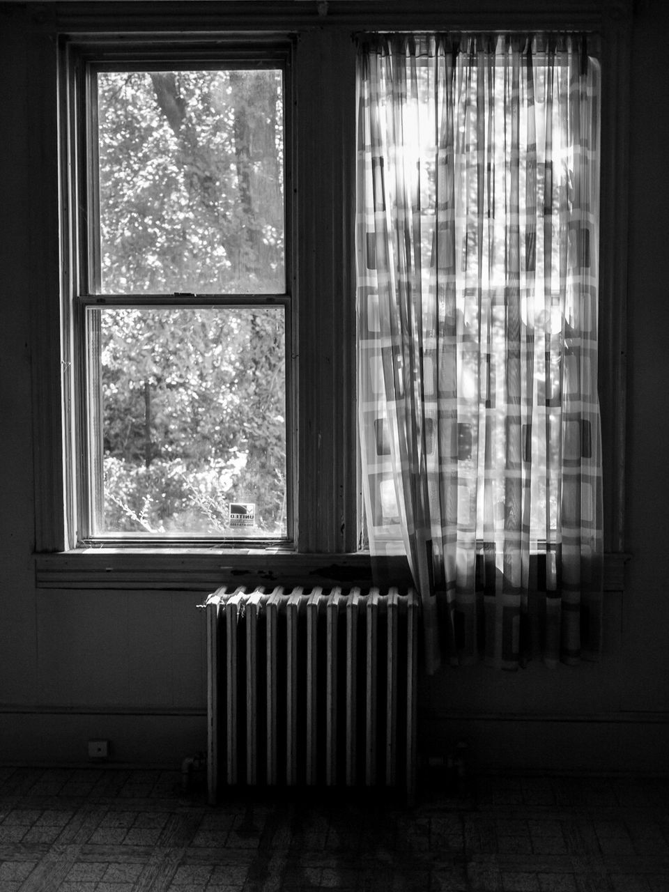 Radiator and curtains against windows