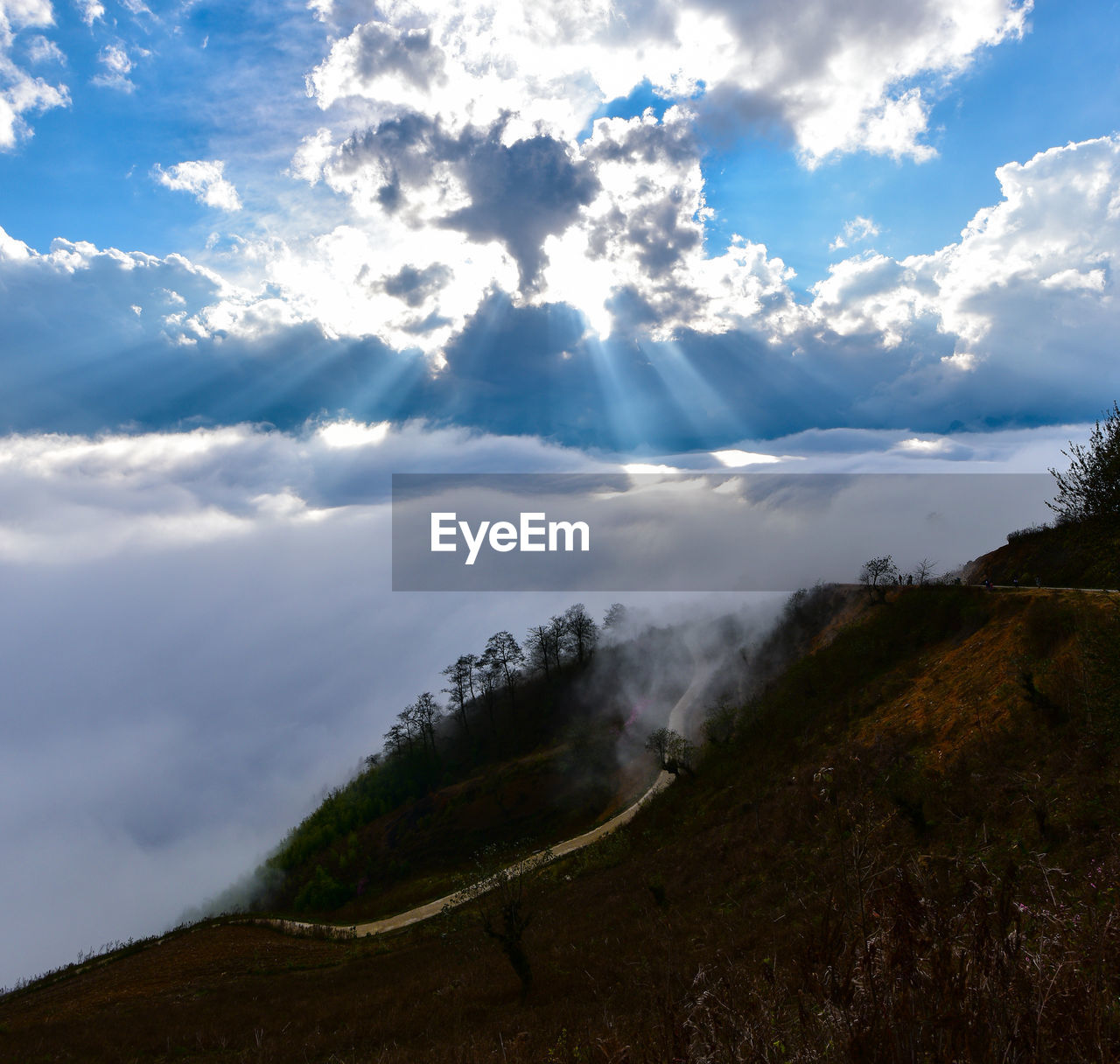 SCENIC VIEW OF CLOUDS OVER MOUNTAIN AGAINST SKY