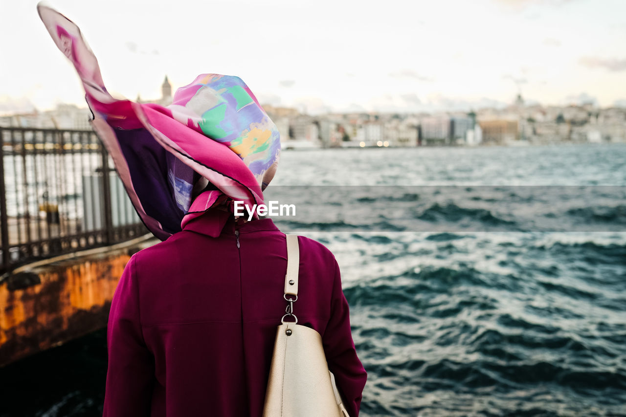 Rear view of woman standing against sea bosphorus sea turkey istanbul