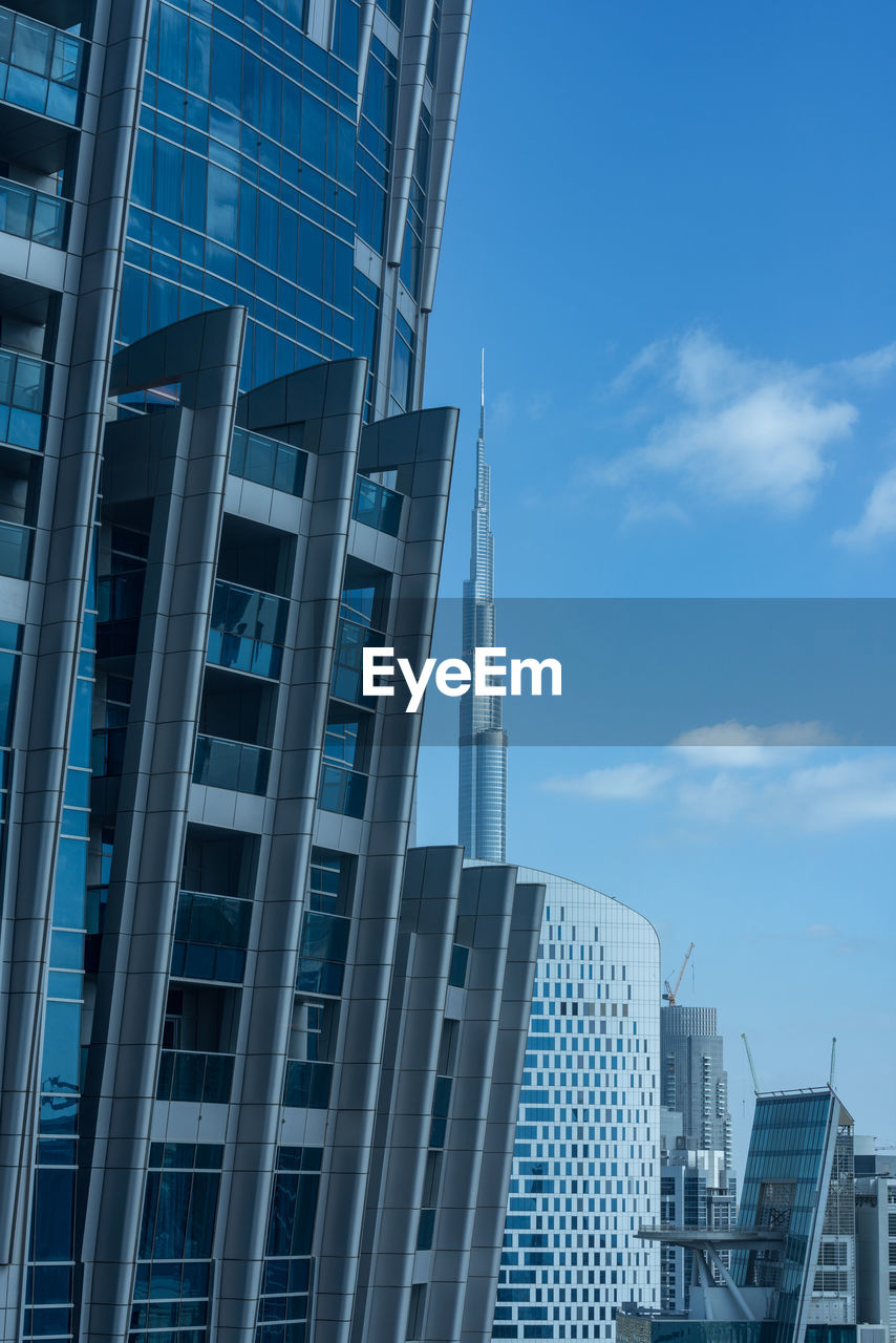 Low angle view of modern buildings against blue sky dubai 