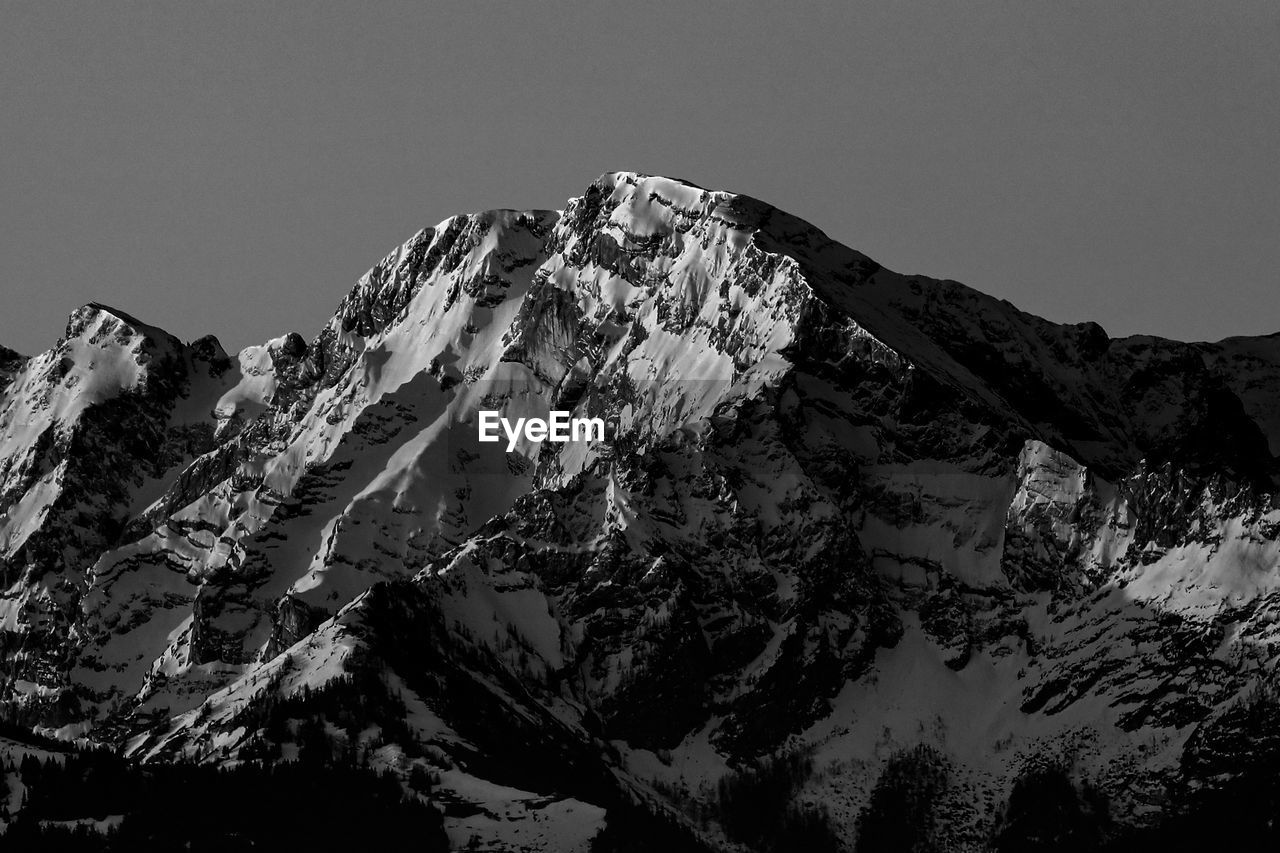 Scenic view of snowcapped mountains against clear sky