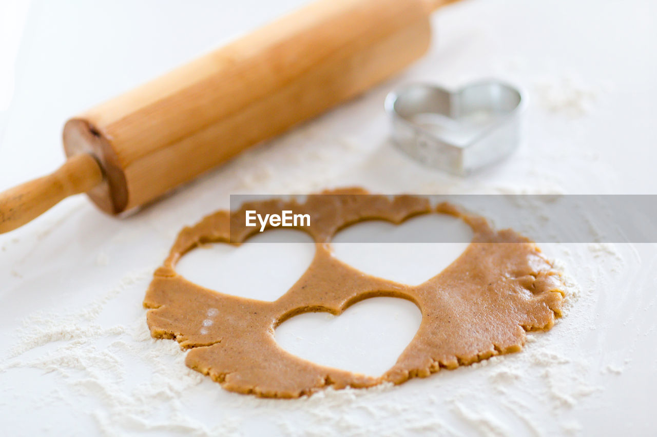 Close-up of heart shape biscuit dough on table