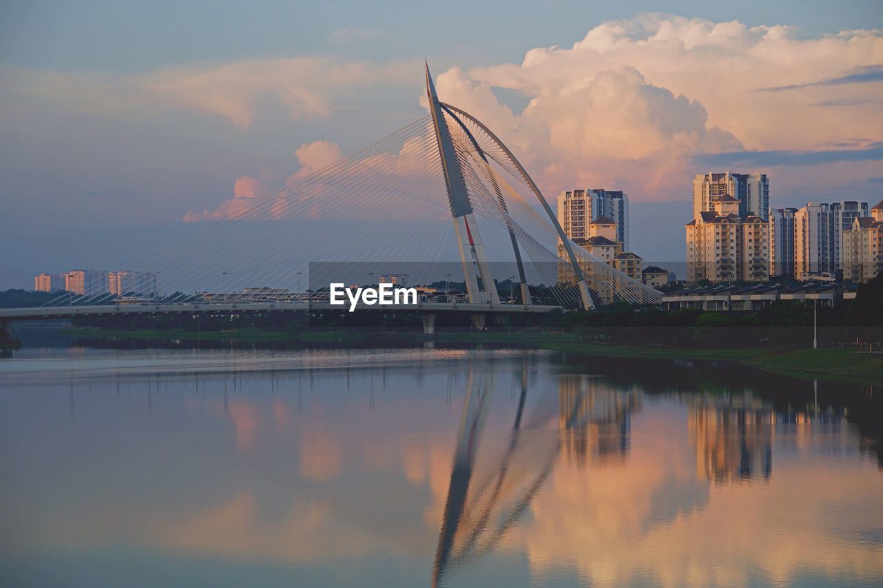 Reflection of buildings in city at sunset