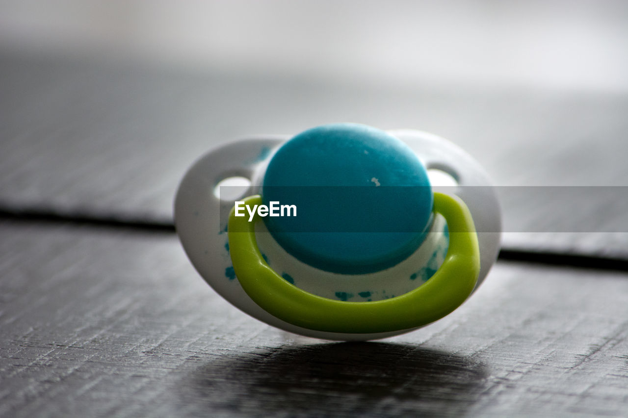 Close-up of pacifier on table