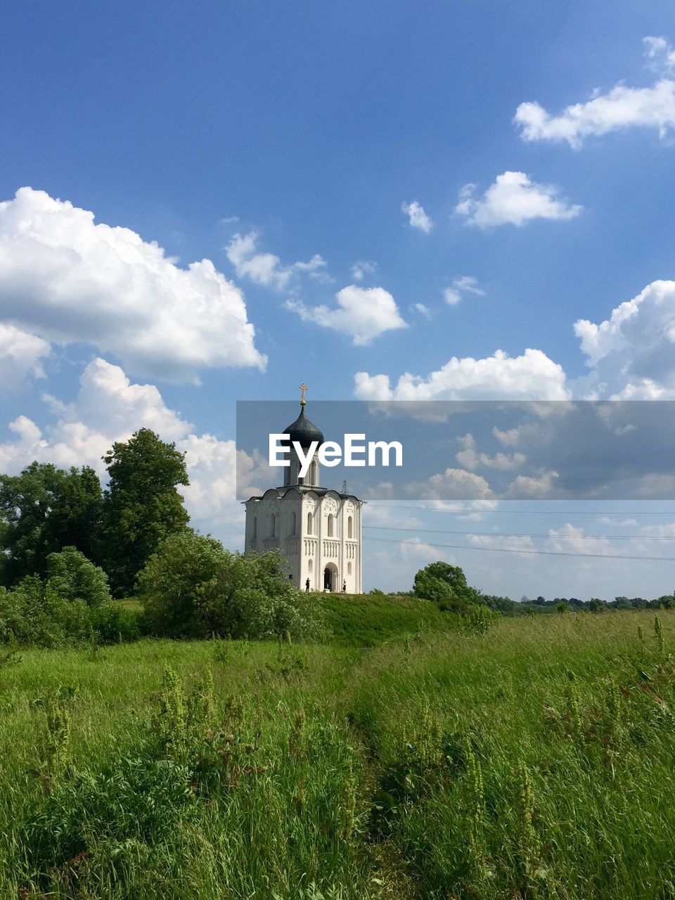 CASTLE ON FIELD AGAINST SKY
