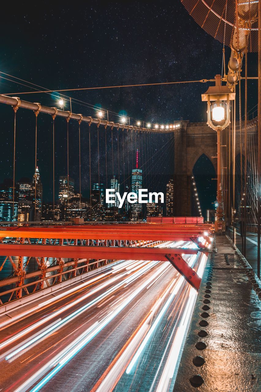 Light trails on bridge in city at night