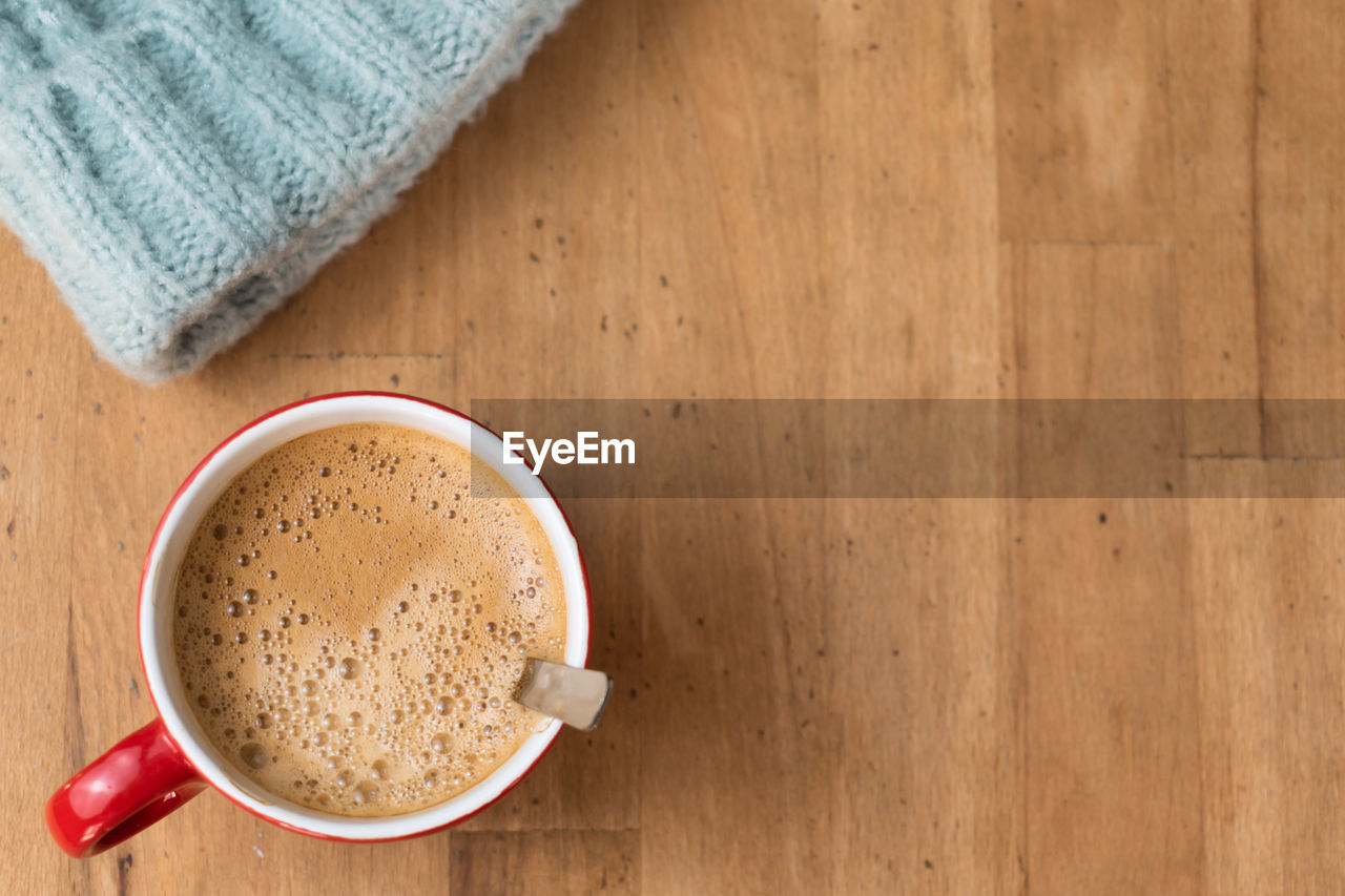 cup, drink, food and drink, coffee, mug, refreshment, wood, coffee cup, hot drink, table, indoors, crockery, directly above, high angle view, freshness, still life, food, tea, copy space, no people, brown, frothy drink, textile, studio shot, wellbeing, healthy eating