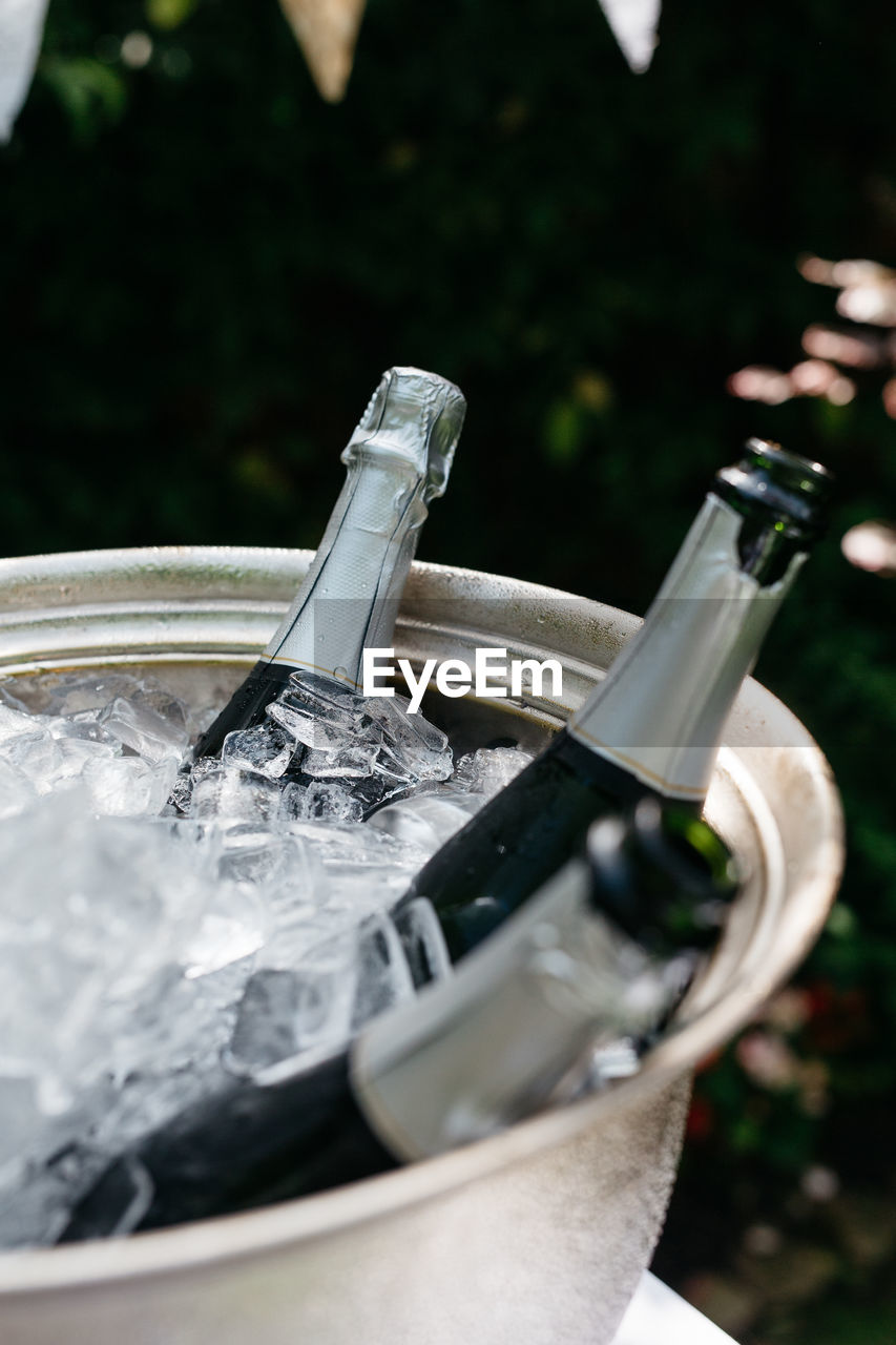 Close-up of bottles with ice in bucket