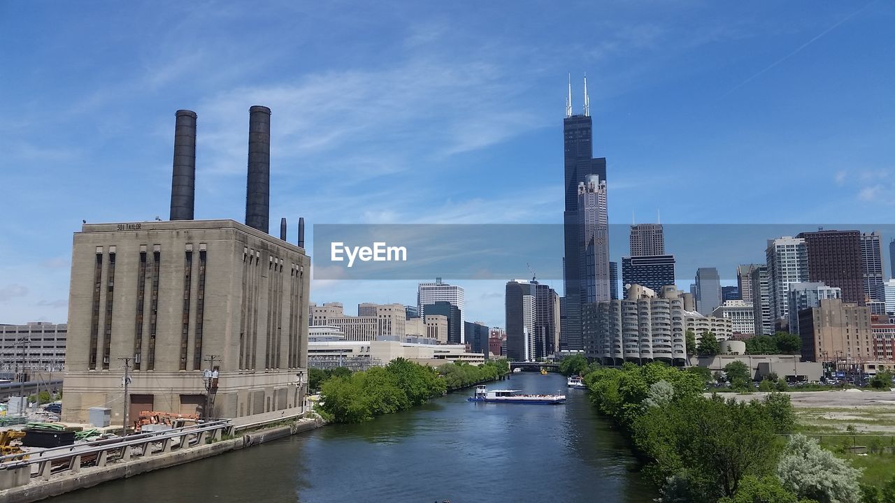 River against willis tower amidst buildings in city