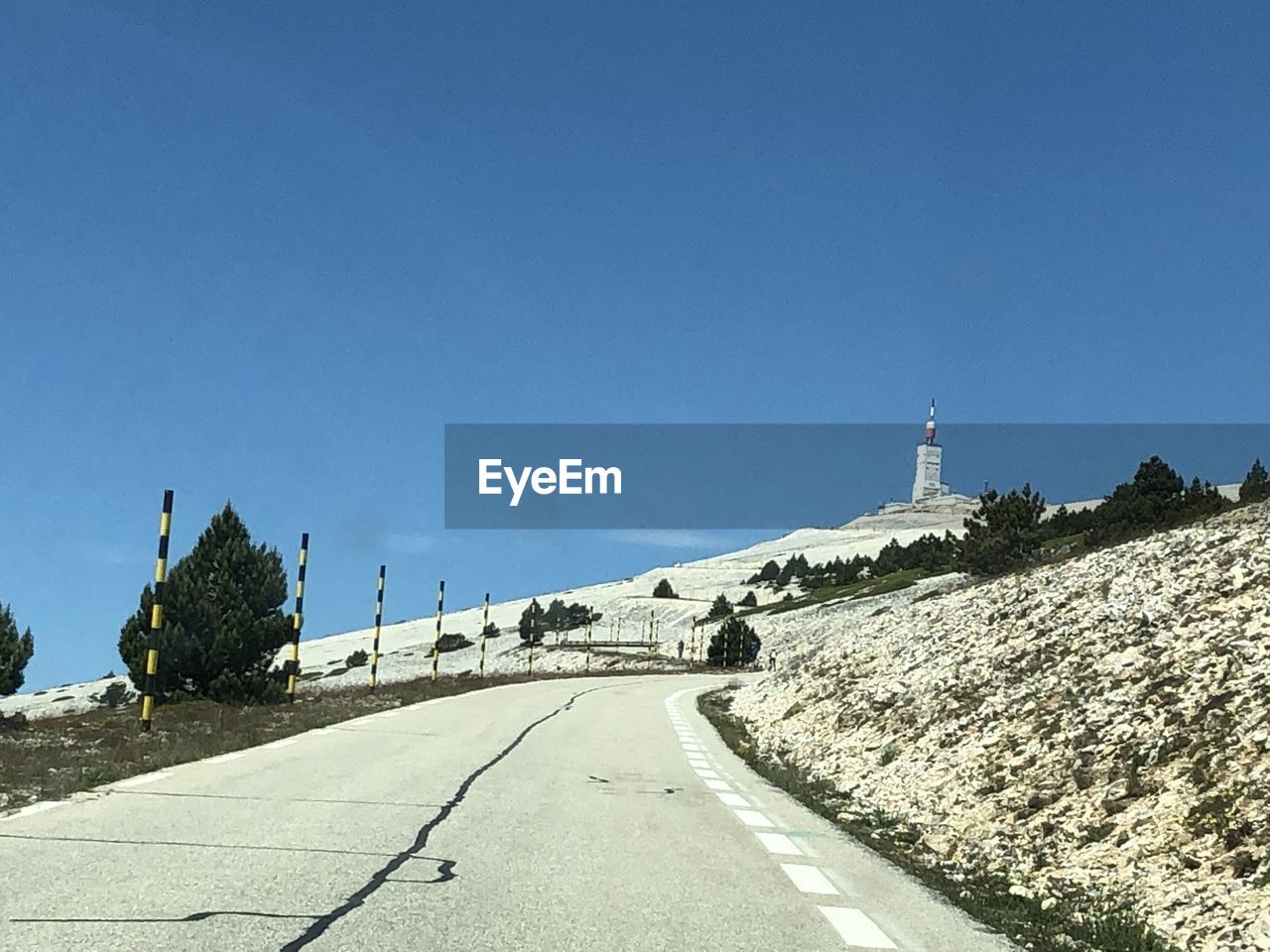 ROAD AMIDST BUILDINGS AGAINST SKY