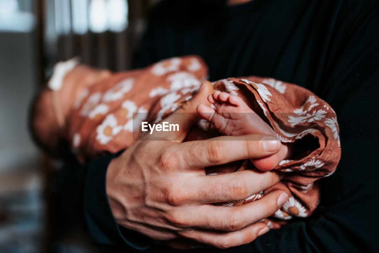 Close-up of woman holding baby