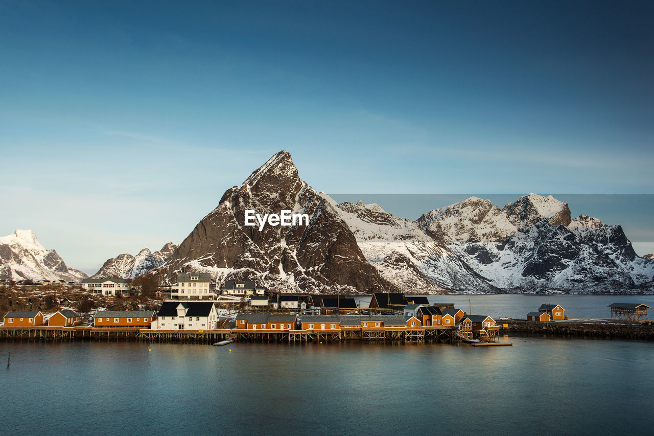 Scenic view of lake and snowcapped mountains against sky