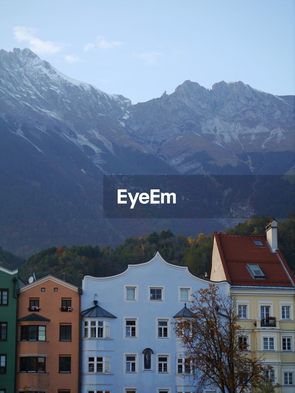 HOUSES AGAINST MOUNTAIN RANGE