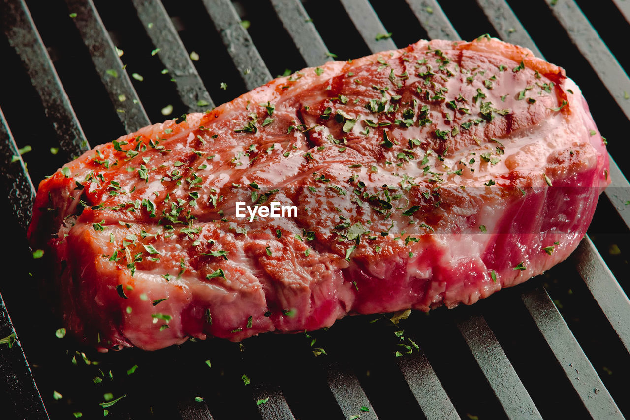 High angle view of meat on barbecue grill