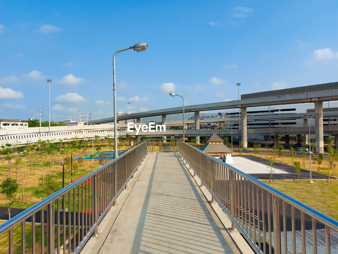 Footbridge over street against sky