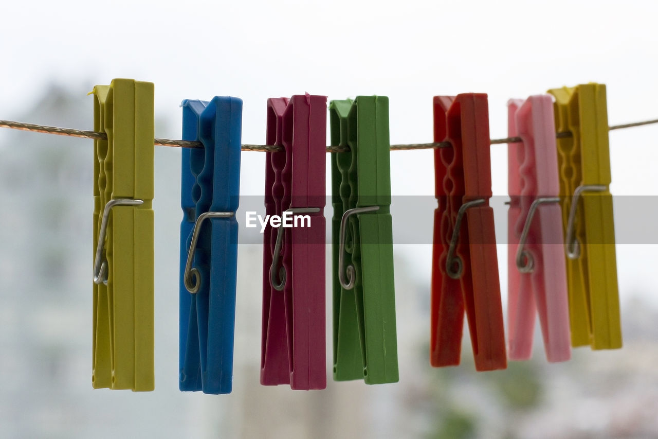Close-up of multi colored clothespins on rope