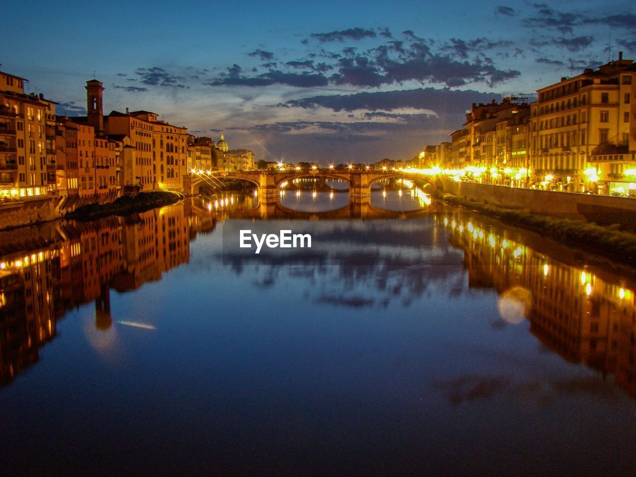 Reflection of illuminated buildings in river at night