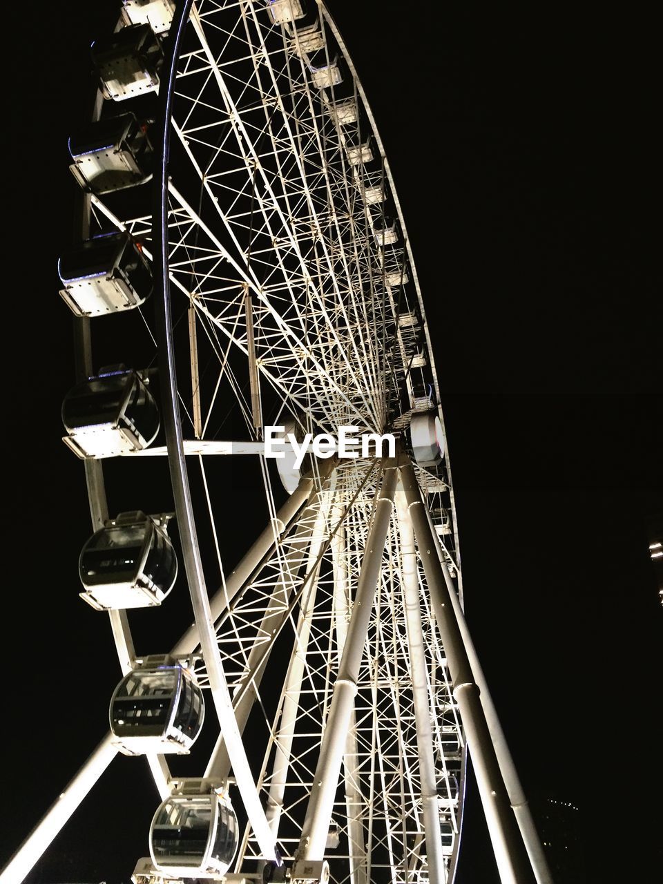 LOW ANGLE VIEW OF FERRIS WHEEL AT NIGHT