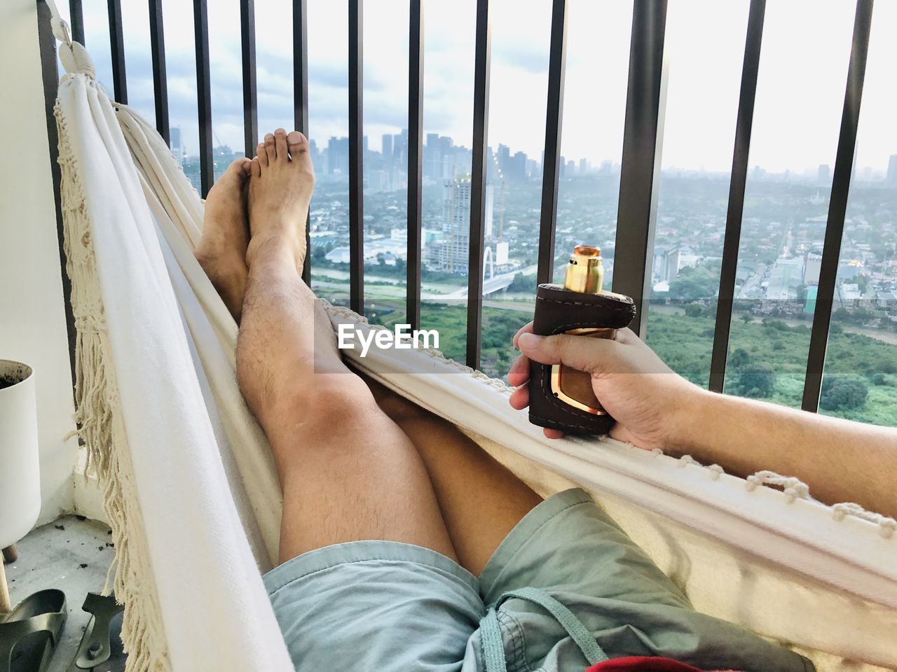 Low section of man sitting on railing