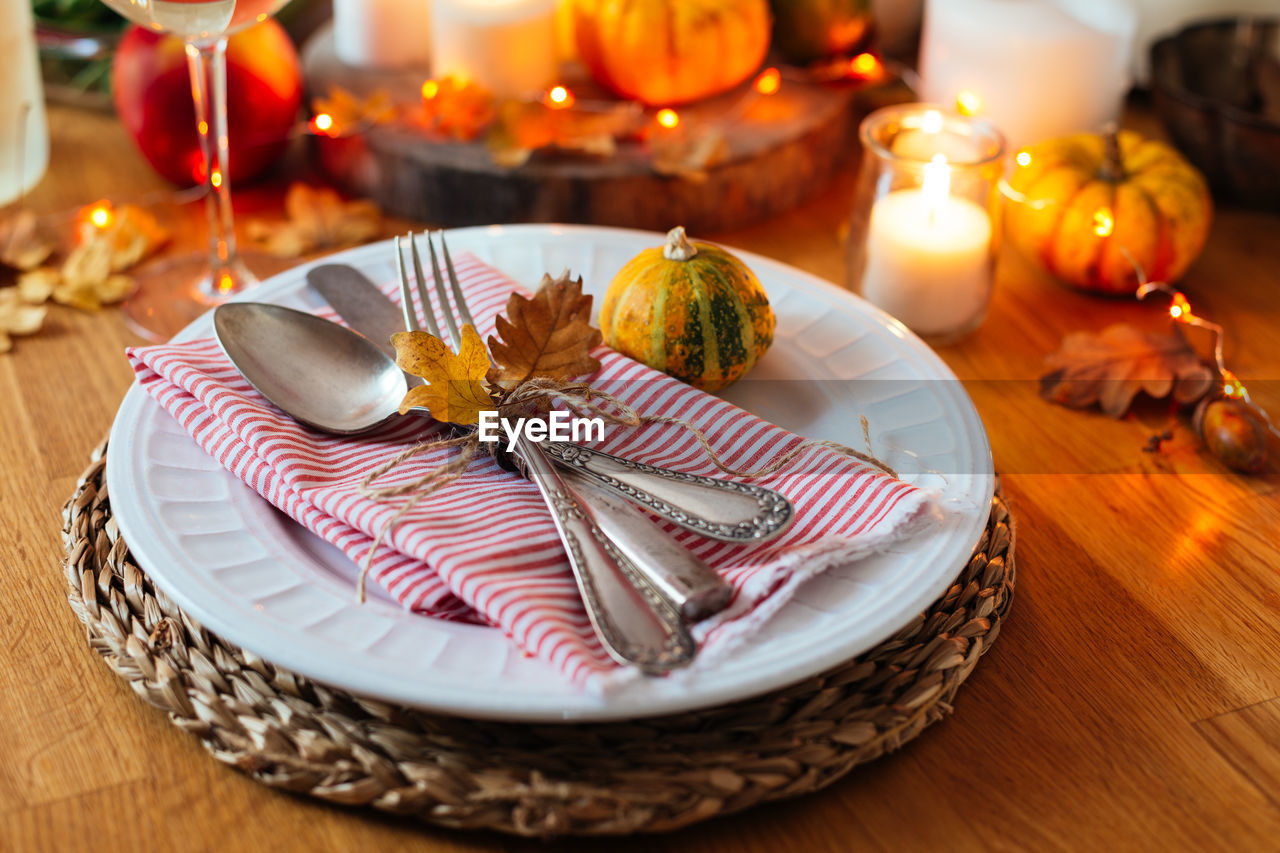 Close-up of plate by decoration on table