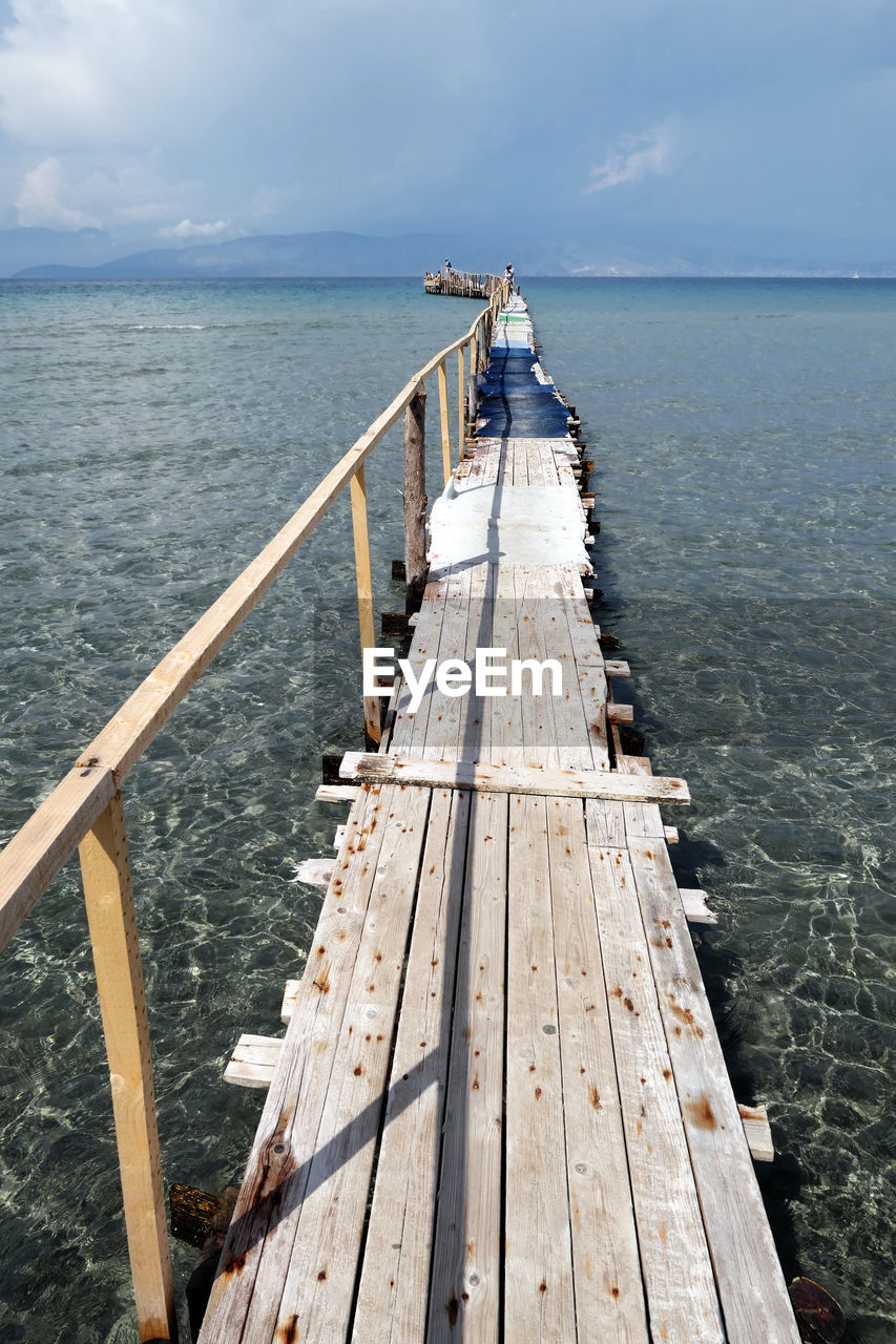 Pier over sea against sky