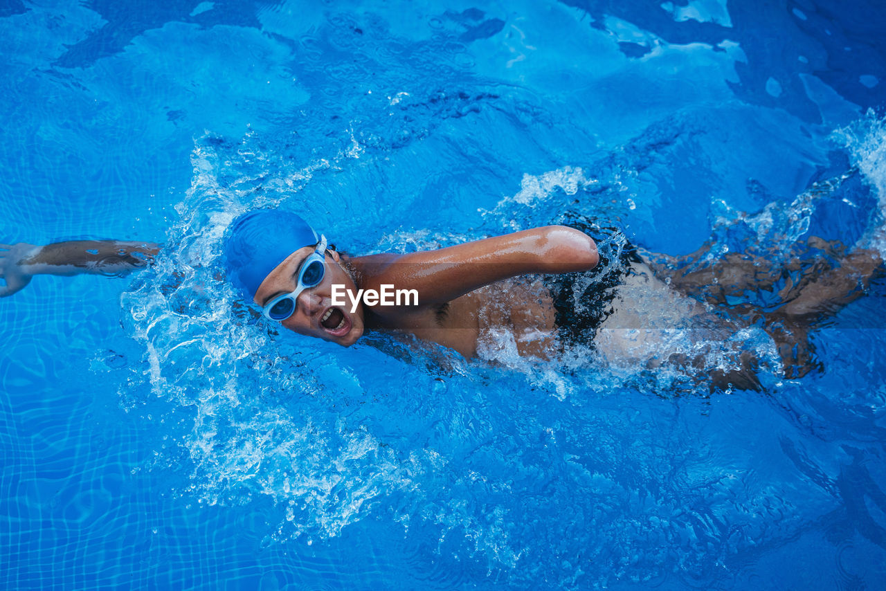 Portrait of paralympic young swimmer crawling in a pool
