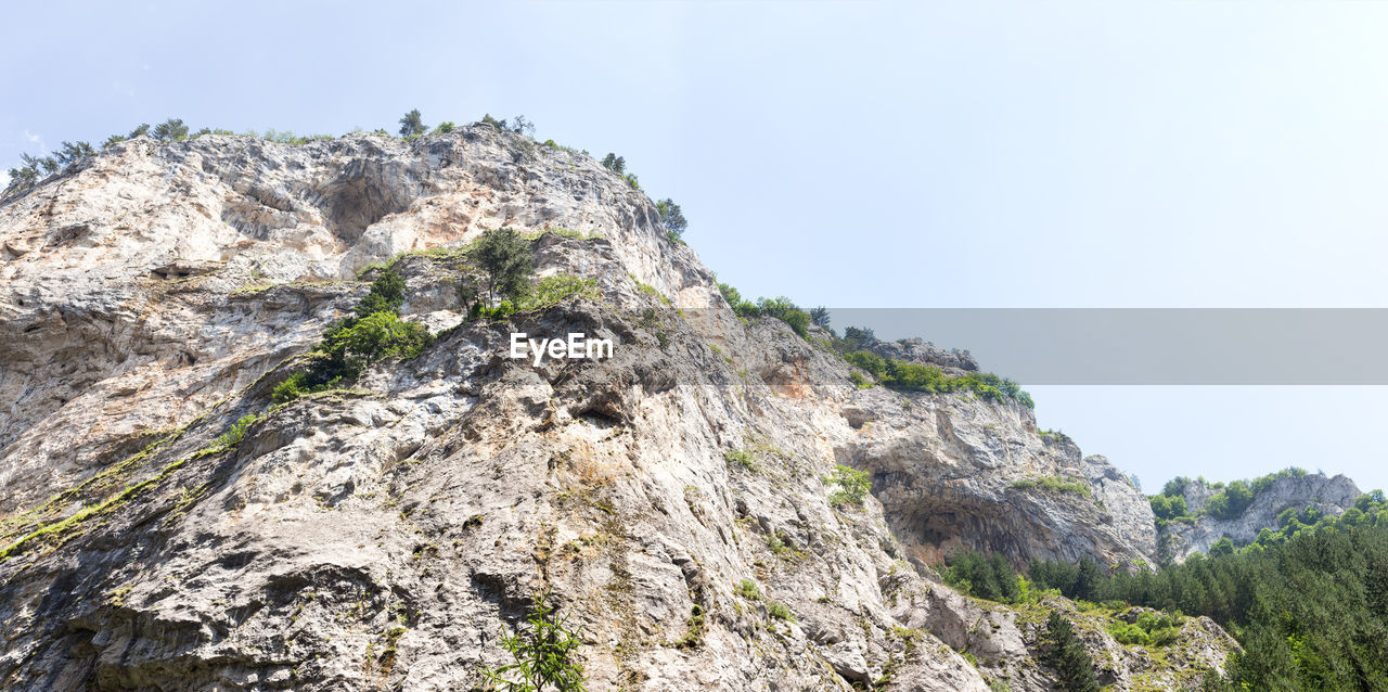 LOW ANGLE VIEW OF ROCK FORMATION AGAINST SKY