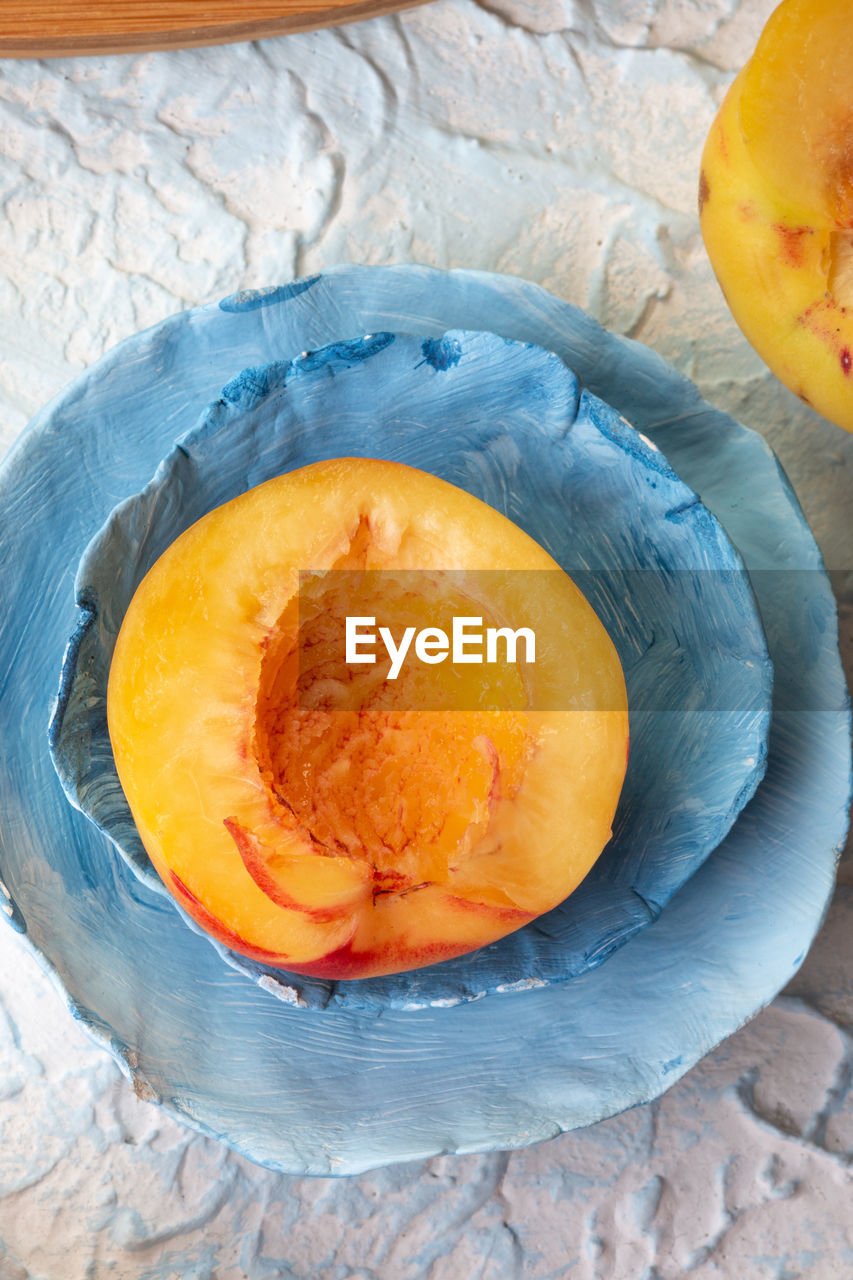 food and drink, food, pumpkin, plant, fruit, healthy eating, produce, vegetable, freshness, wellbeing, orange color, orange, no people, high angle view, indoors, wood, close-up, winter squash