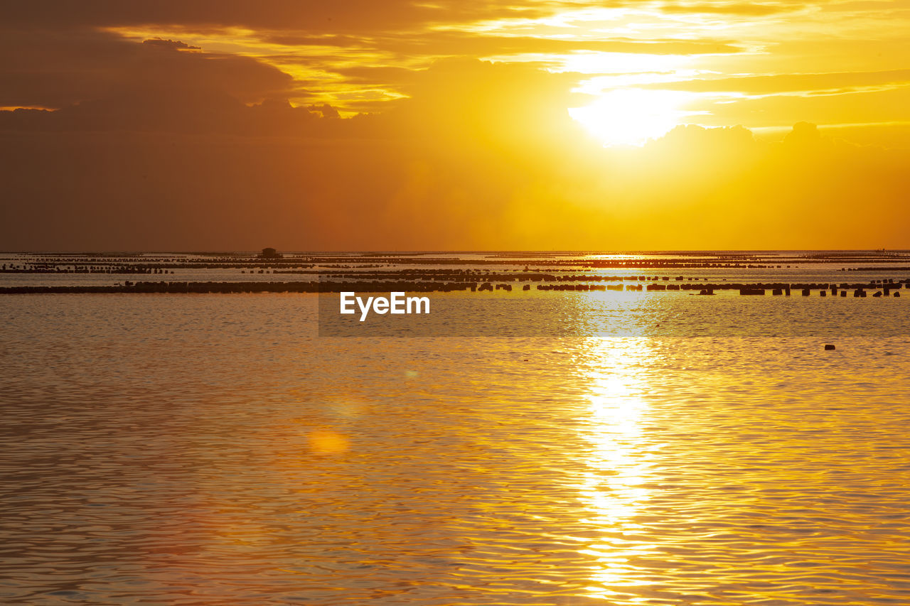 SCENIC VIEW OF SEA AGAINST SKY AT SUNSET