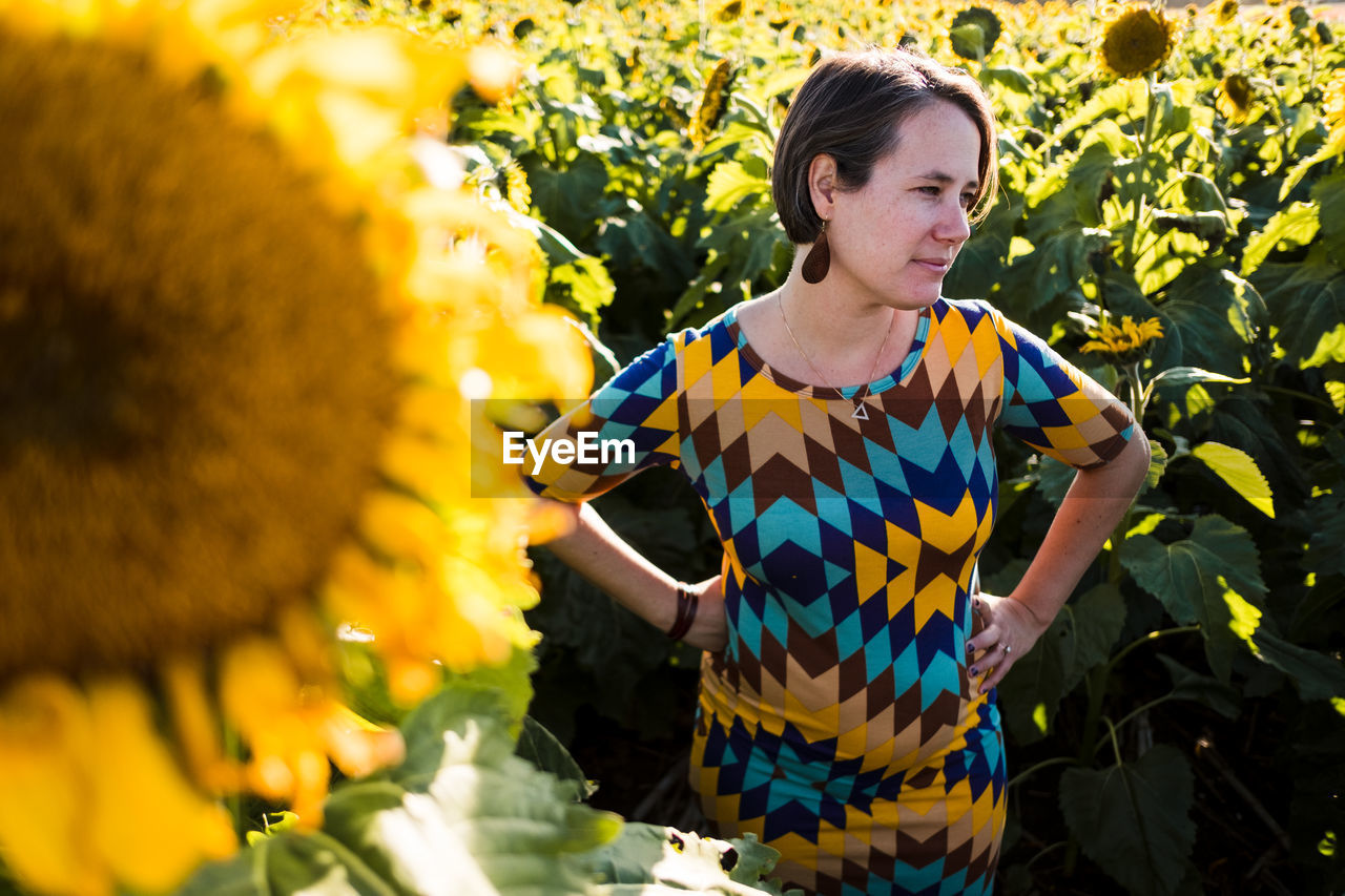 Woman standing in a sunflower field in kansas city mo