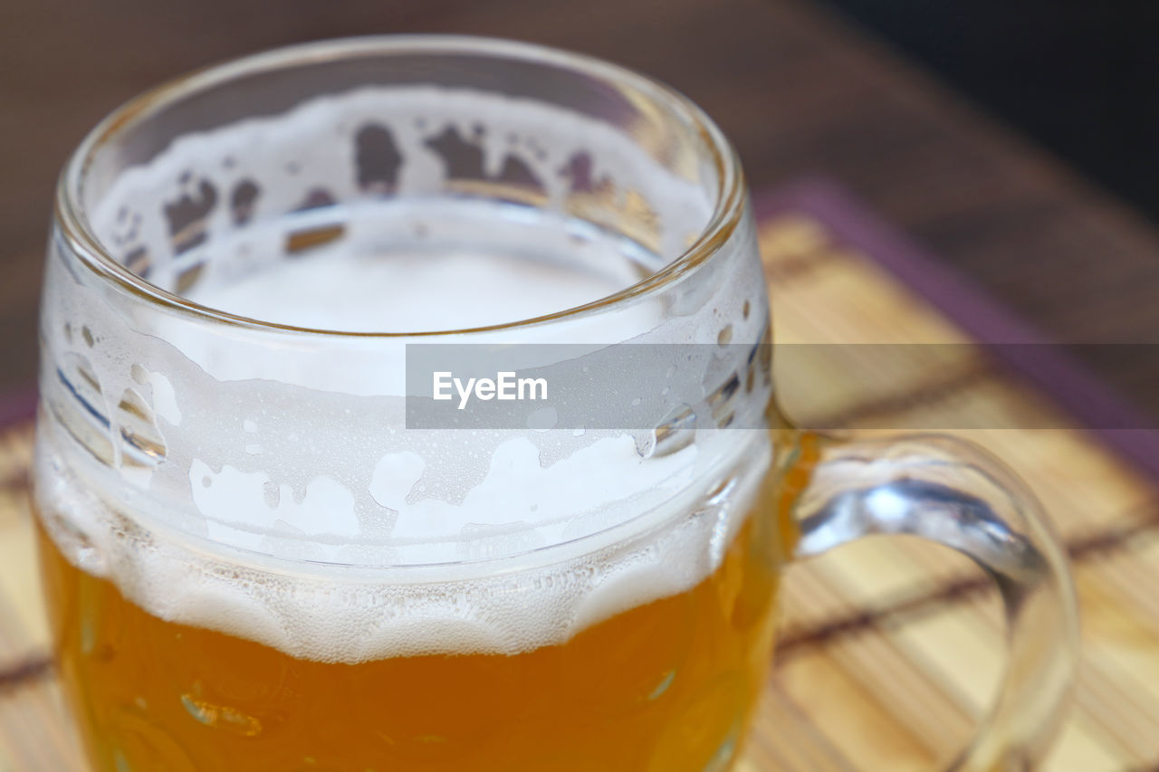 Close-up of beer glass on wooden table