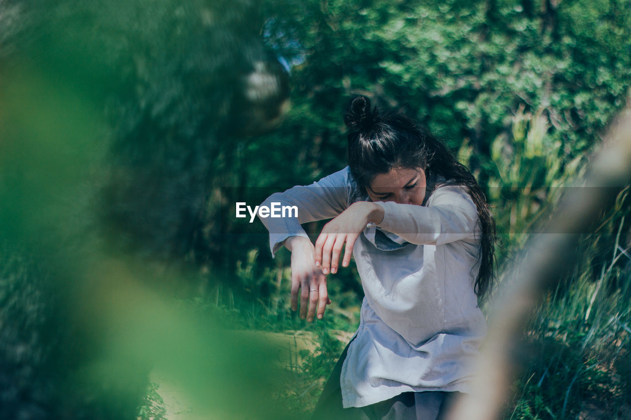 Woman dancing in forest