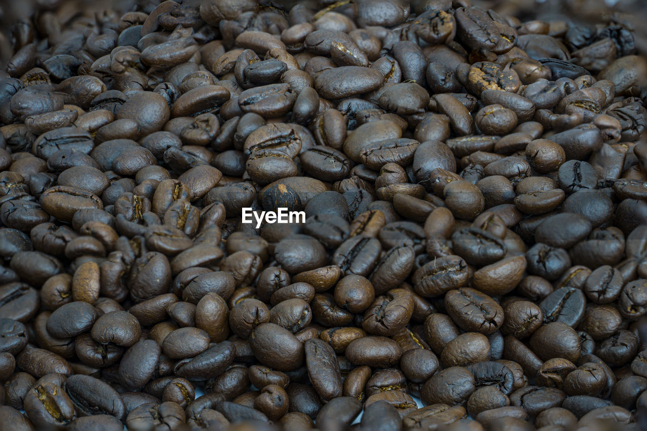 FULL FRAME SHOT OF COFFEE BEANS IN BACKGROUND