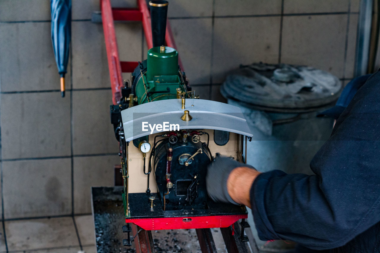 Cropped hand of mechanic working at workshop