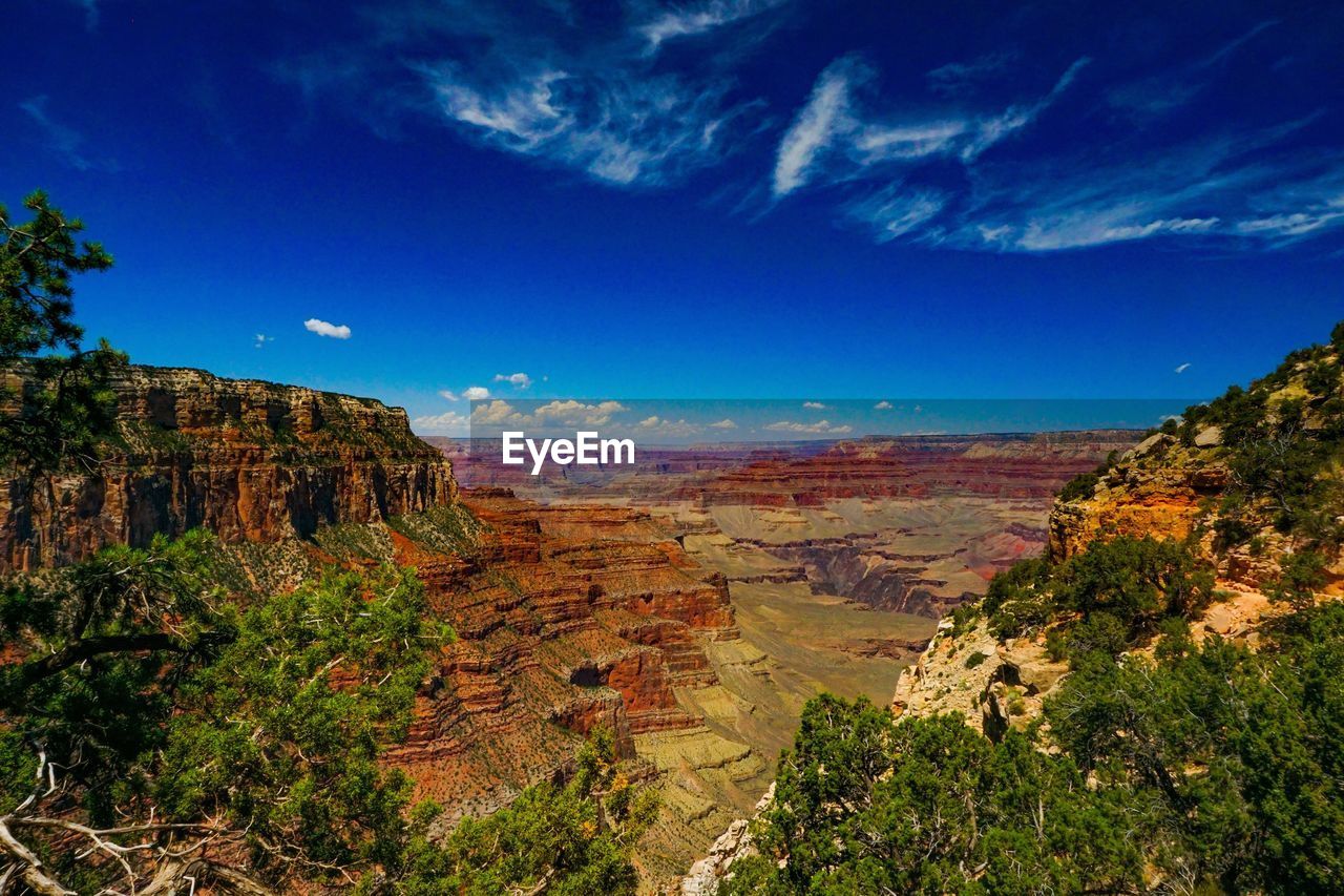 Scenic view of landscape against blue sky