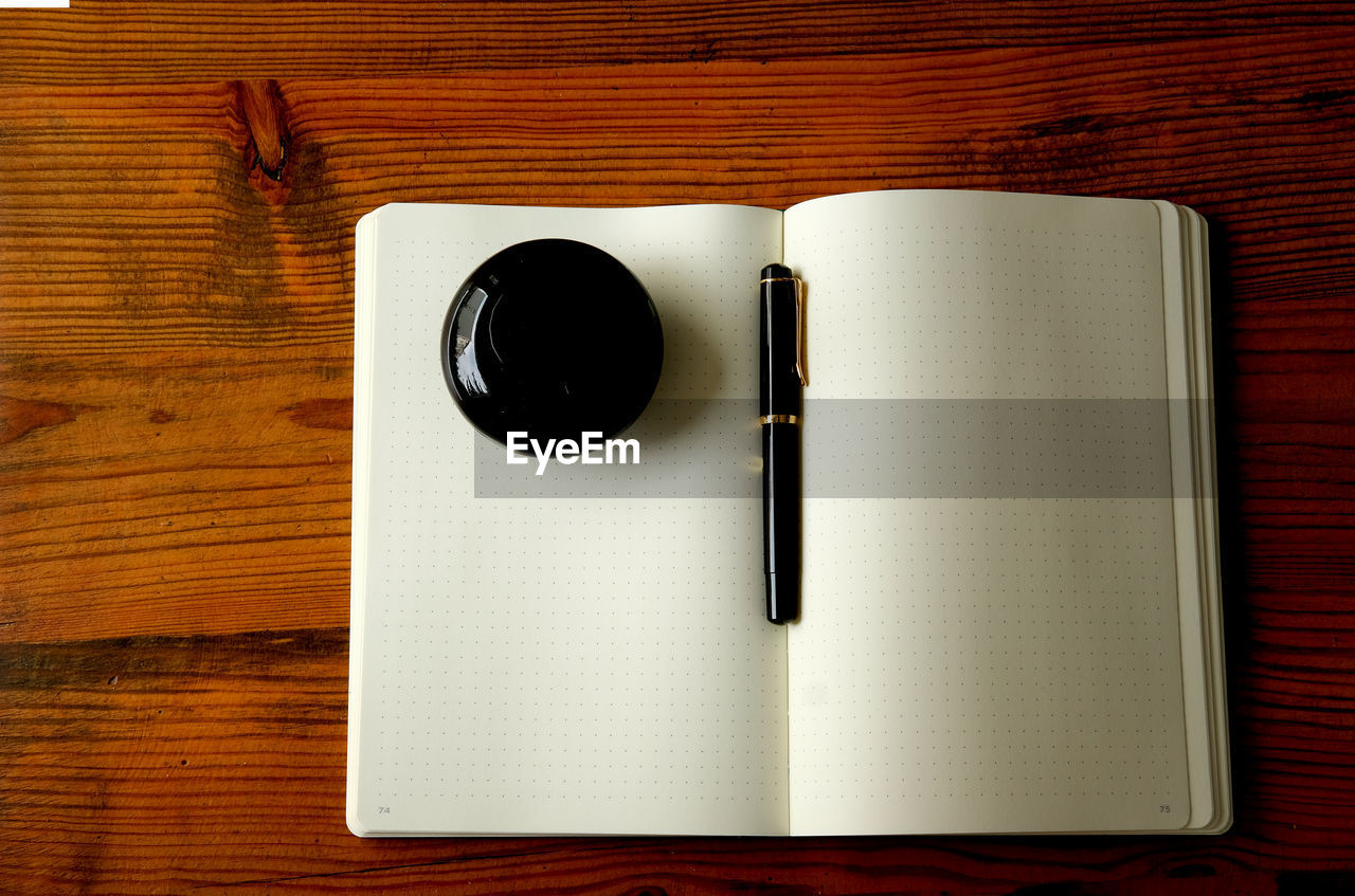 wood, table, directly above, pen, indoors, no people, still life, high angle view, paper, brown, food and drink, diary, note pad, book, communication, publication, cup