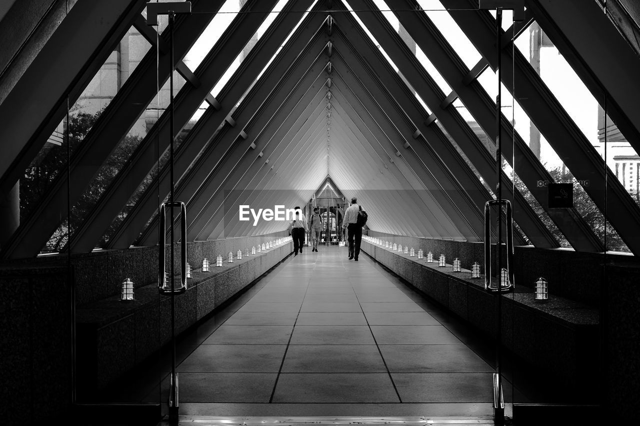 Men walking in covered footbridge