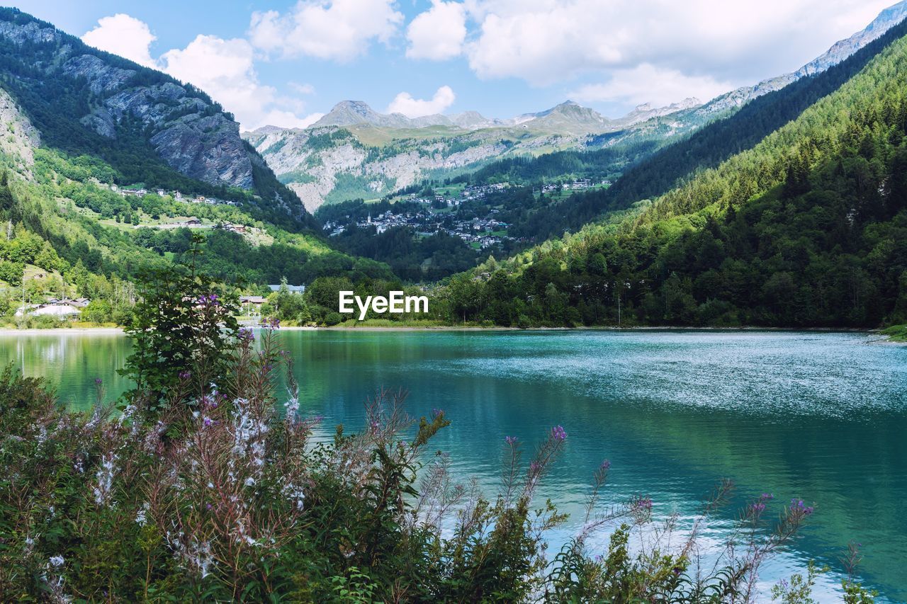 Scenic view of lake and mountains against sky