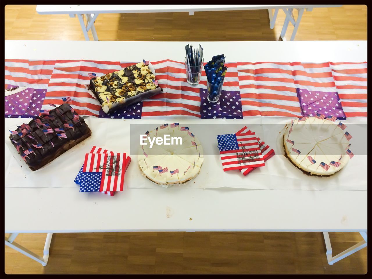 Cakes and brownies on table with american flags