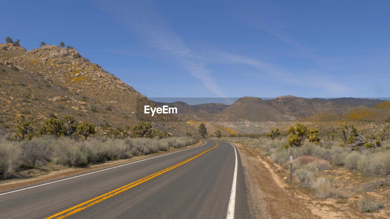 ROAD LEADING TOWARDS MOUNTAINS