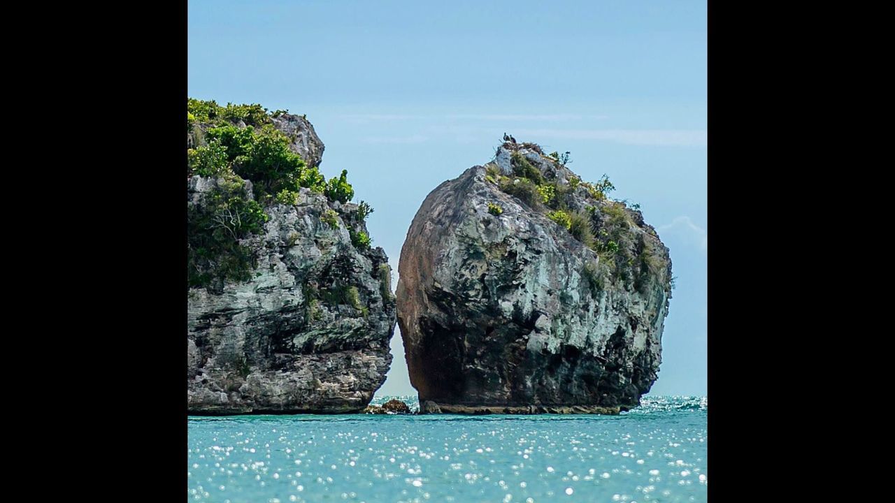 ROCKS IN SEA AGAINST SKY