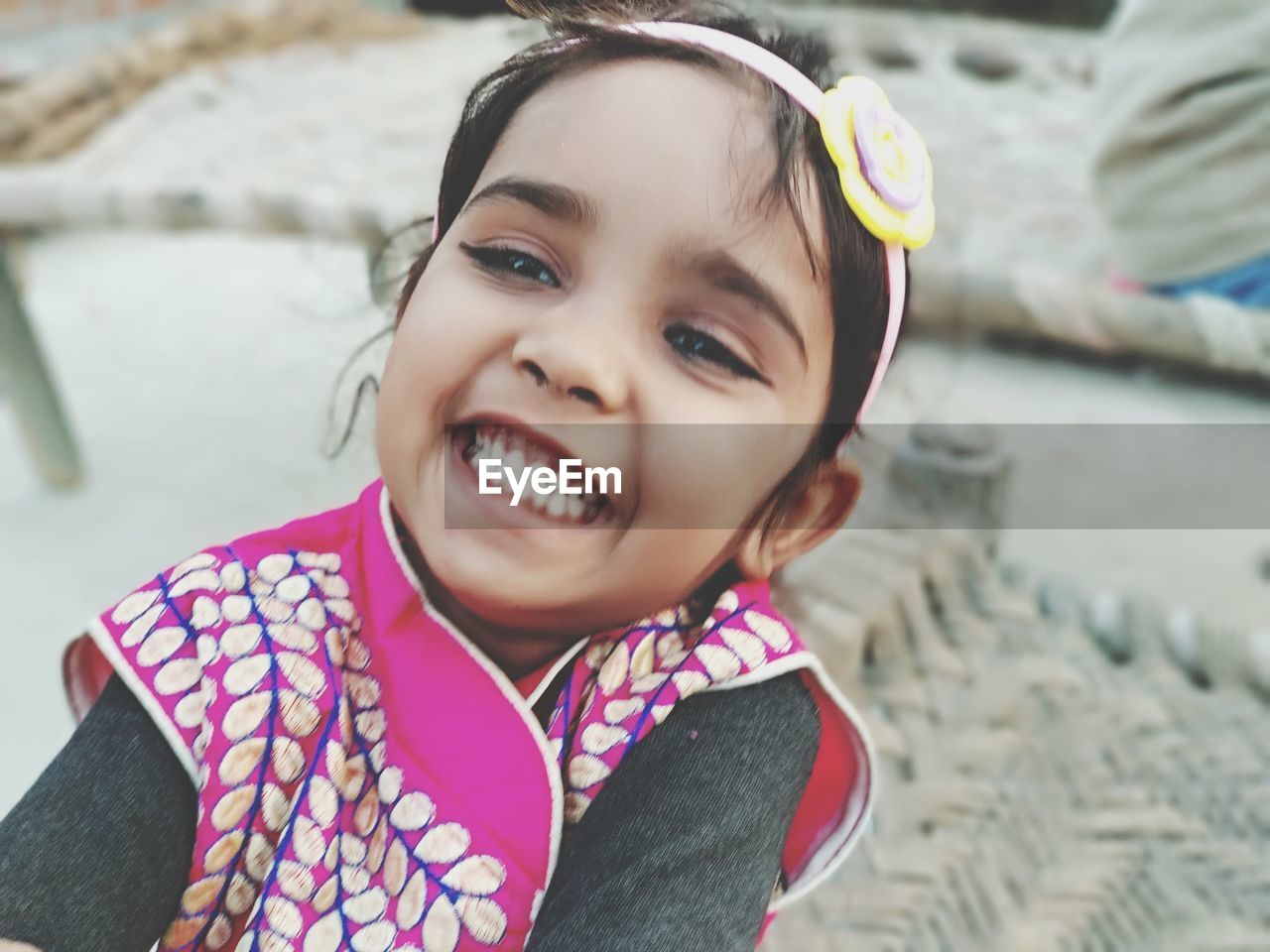 High angle portrait of smiling girl standing outdoors