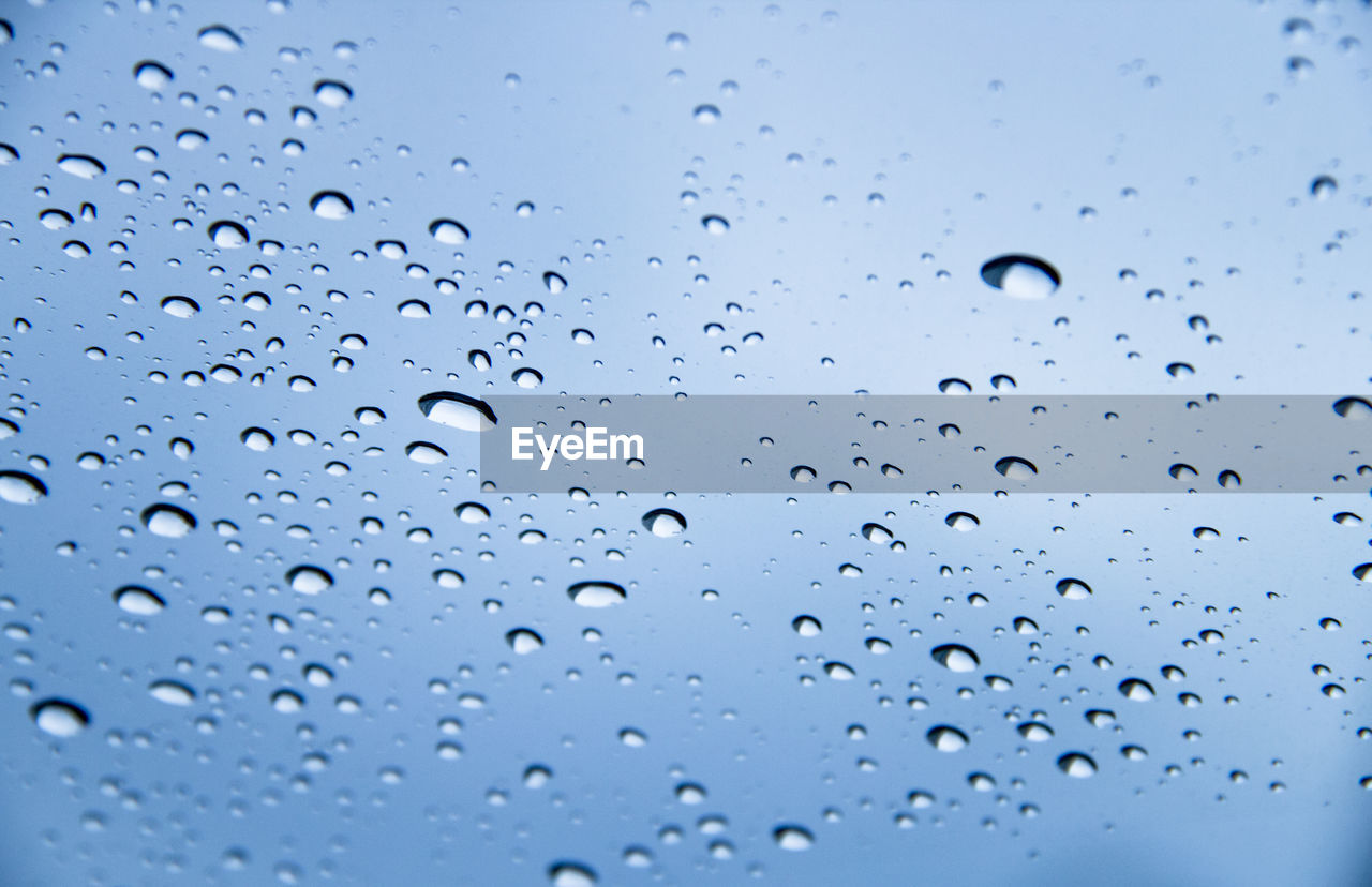 Full frame shot of water droplets on the window after raining