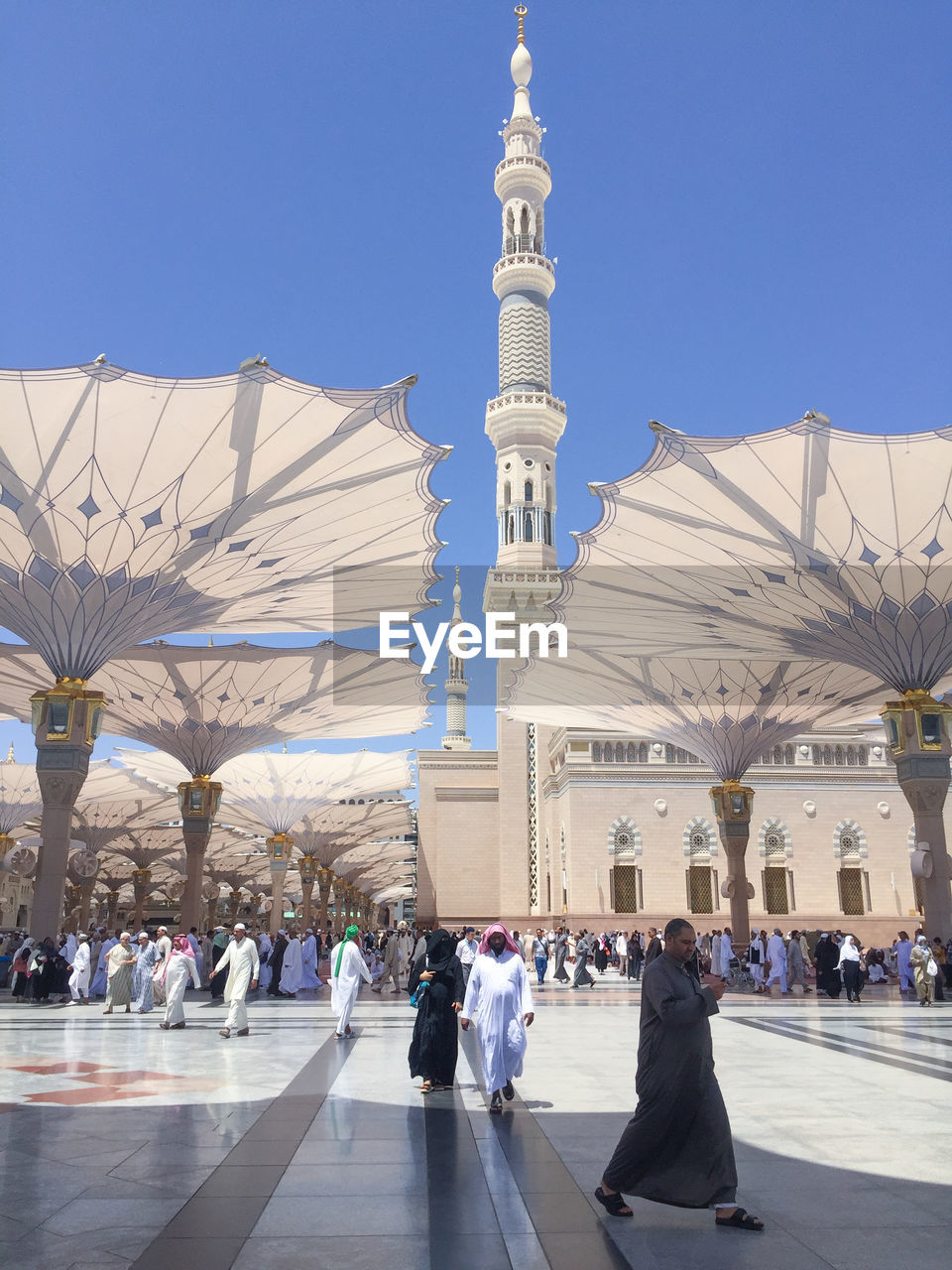 PEOPLE AT CATHEDRAL AGAINST CLEAR BLUE SKY