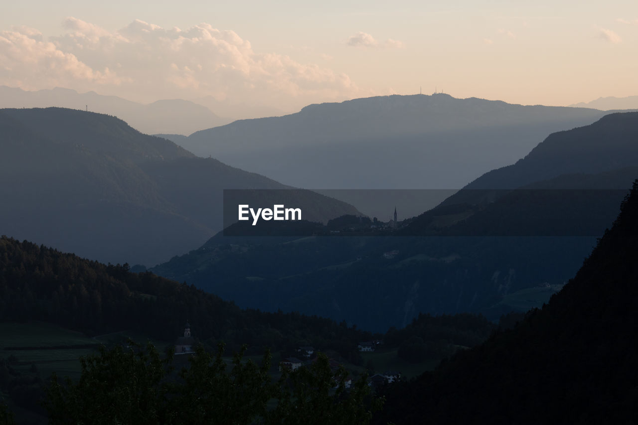 Scenic view of silhouette mountains against sky at sunset