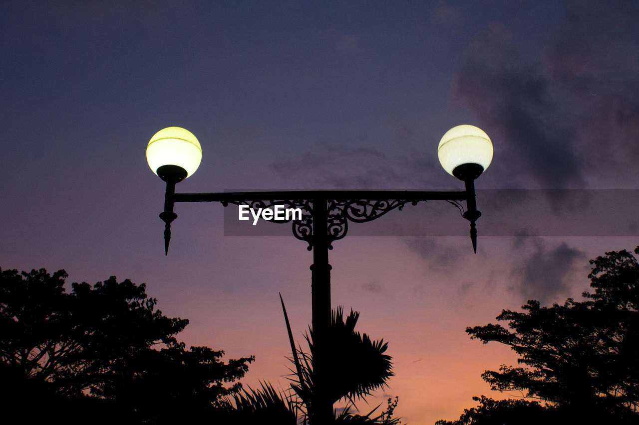 Low angle view of the streetlamp against sky towards sunset