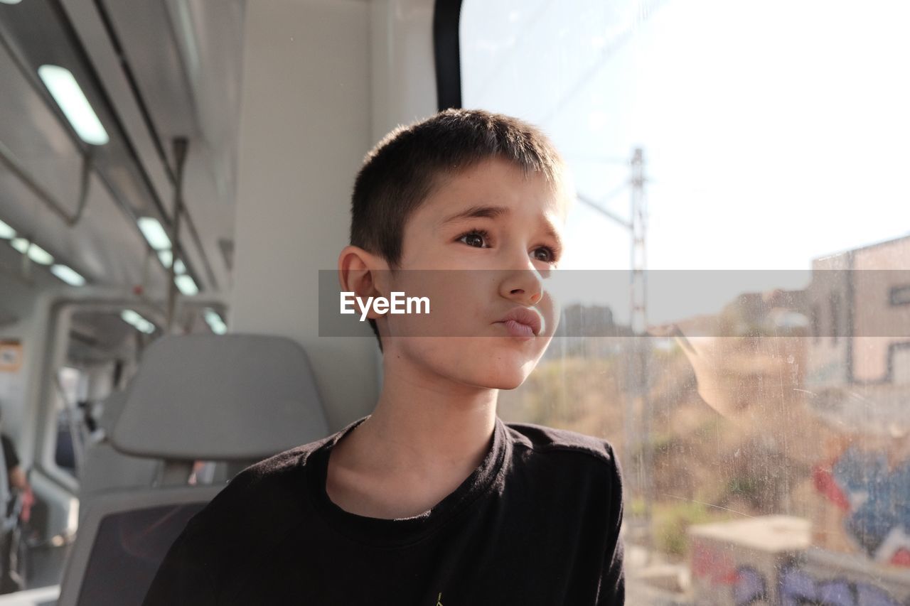 Cute boy sitting in bus