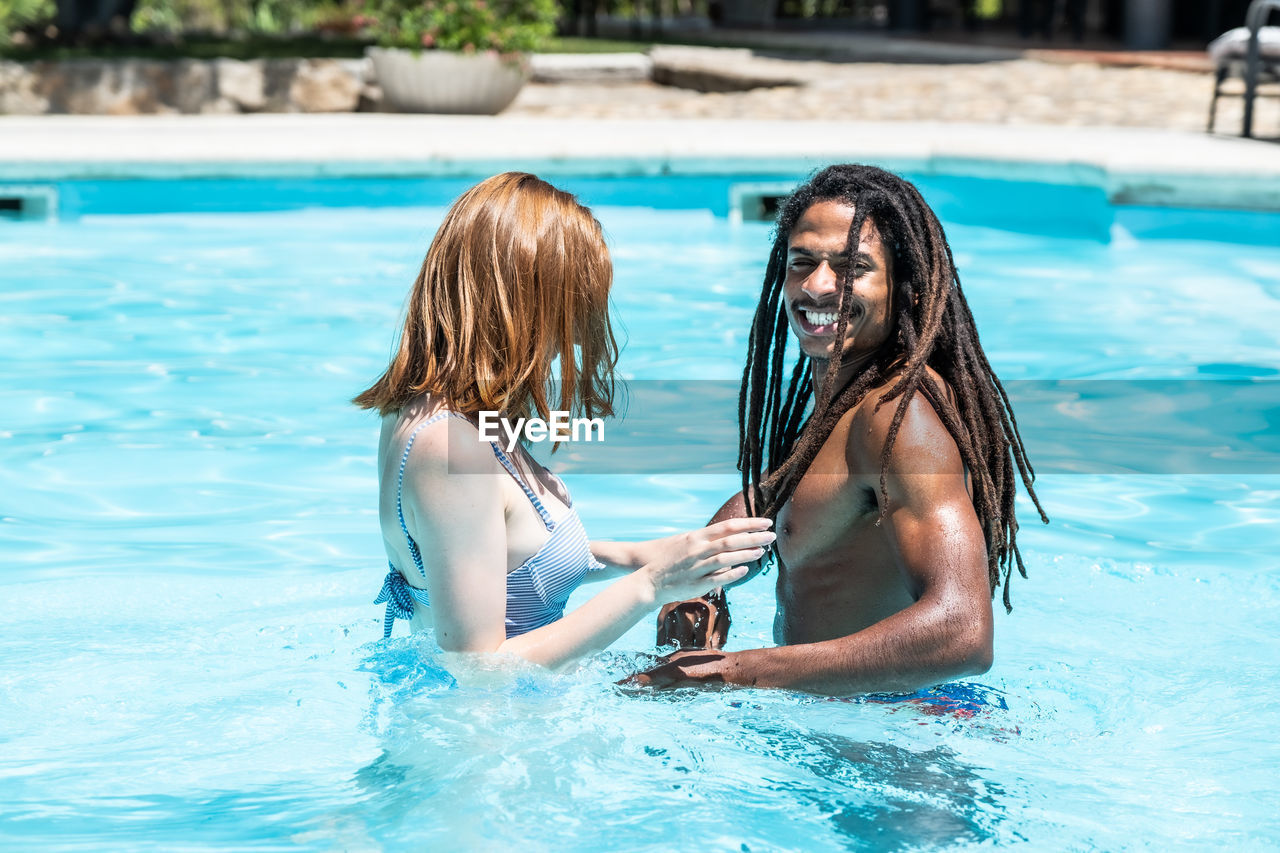 Young couple swimming in pool