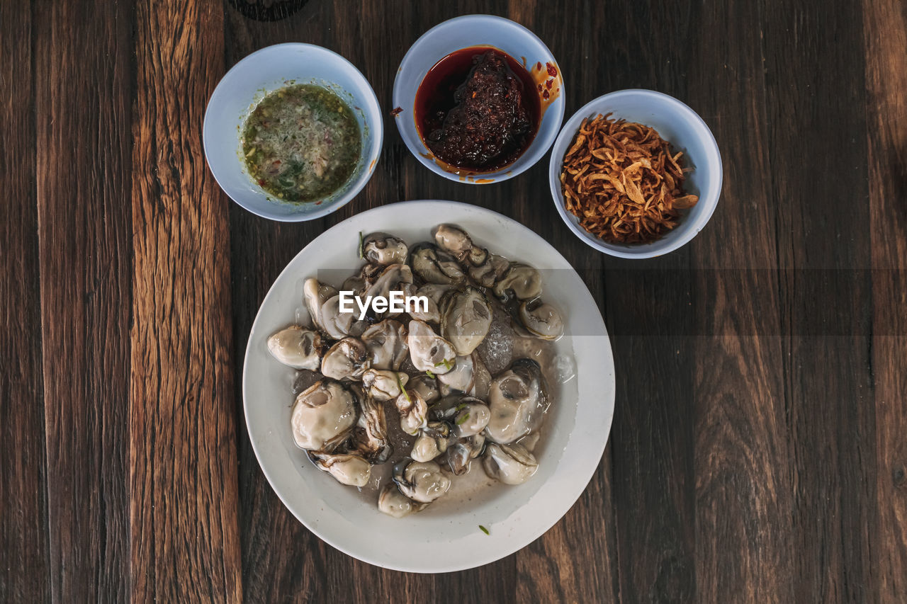 food and drink, food, healthy eating, wood, table, wellbeing, freshness, bowl, directly above, no people, high angle view, ingredient, indoors, spice, plate, herb, vegetable, seafood, still life, crockery, meal