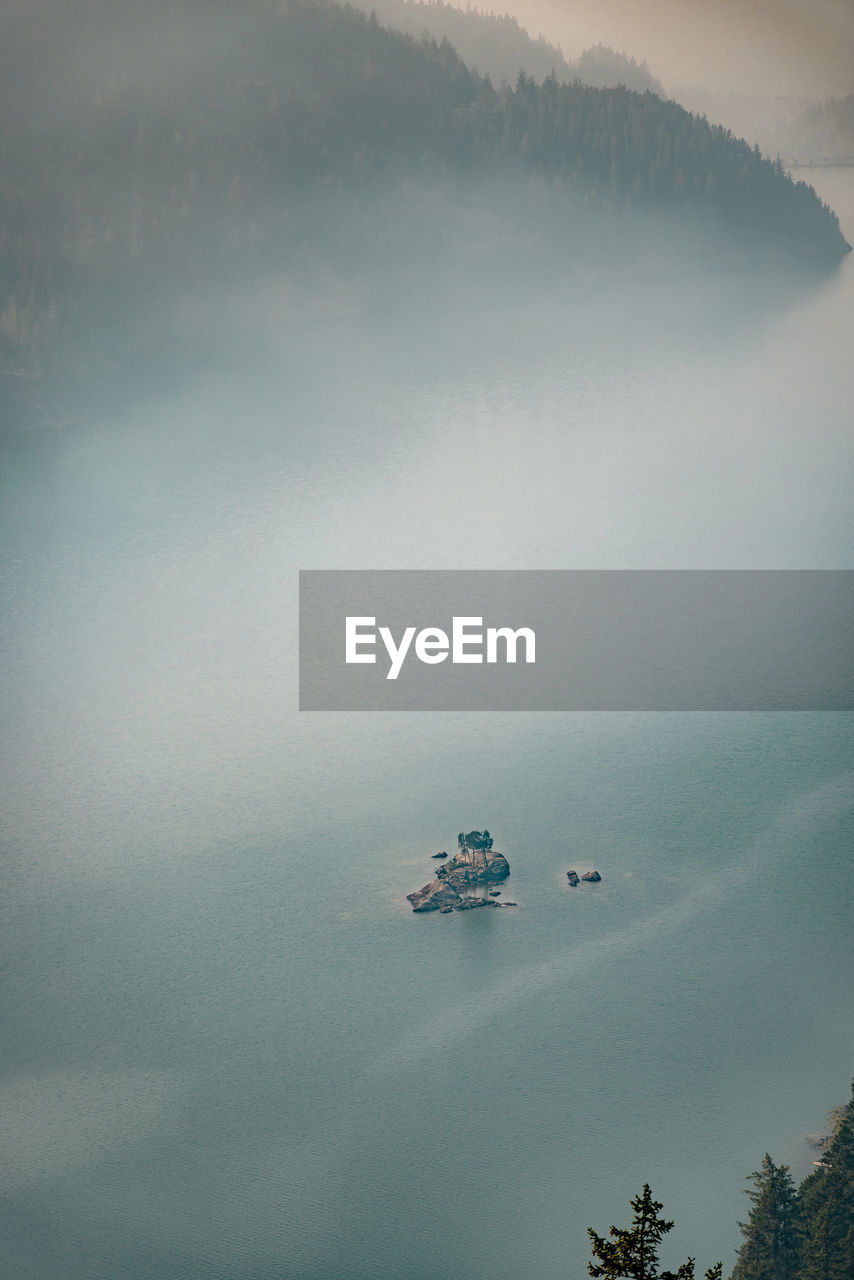 Smoke from nearby wild fires settle at diablo lake in north cascades national park in late summer. 